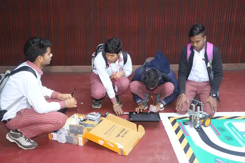 Students testing their robot on a line-following competition mat